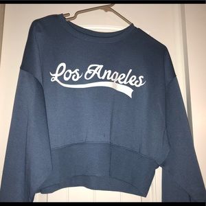 Cropped, blue crew neck sweater